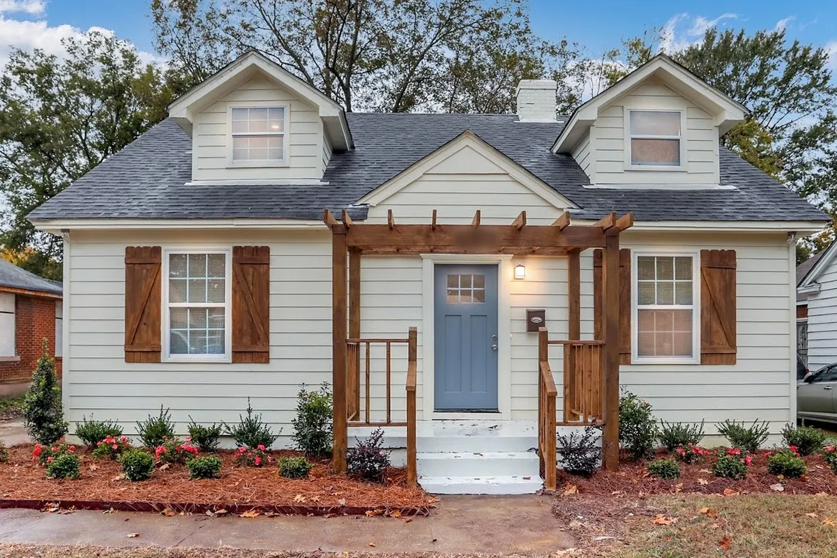 Front after renovation, Boarded-up cape, brought back