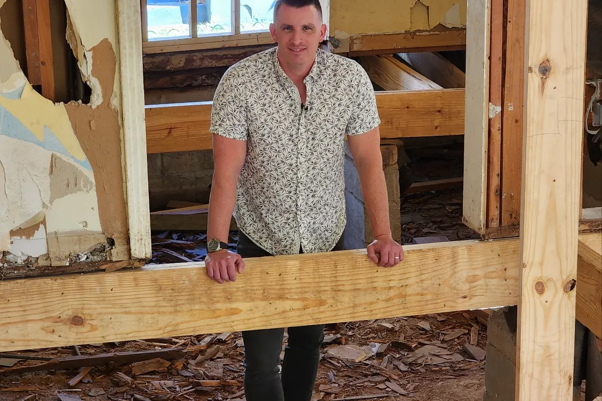 Andrew Glisson standing in the framing of one of our own Memphis rental renovations